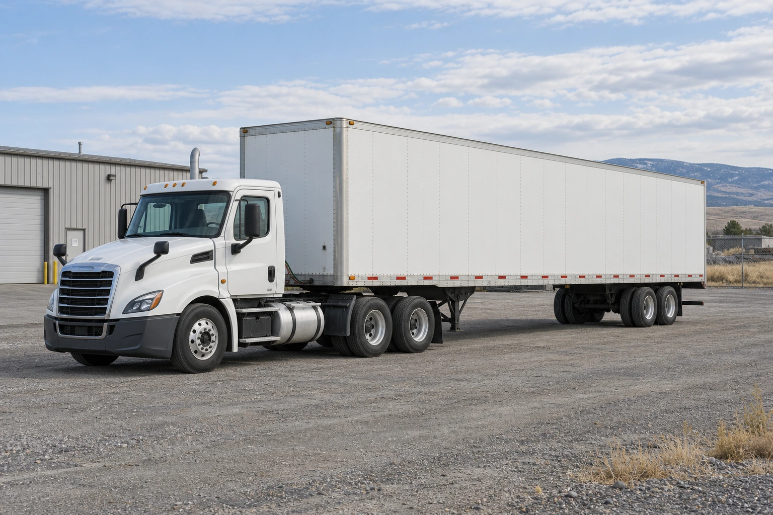 Unbranded white tractor and dry van in a northern high-plains industrial yard